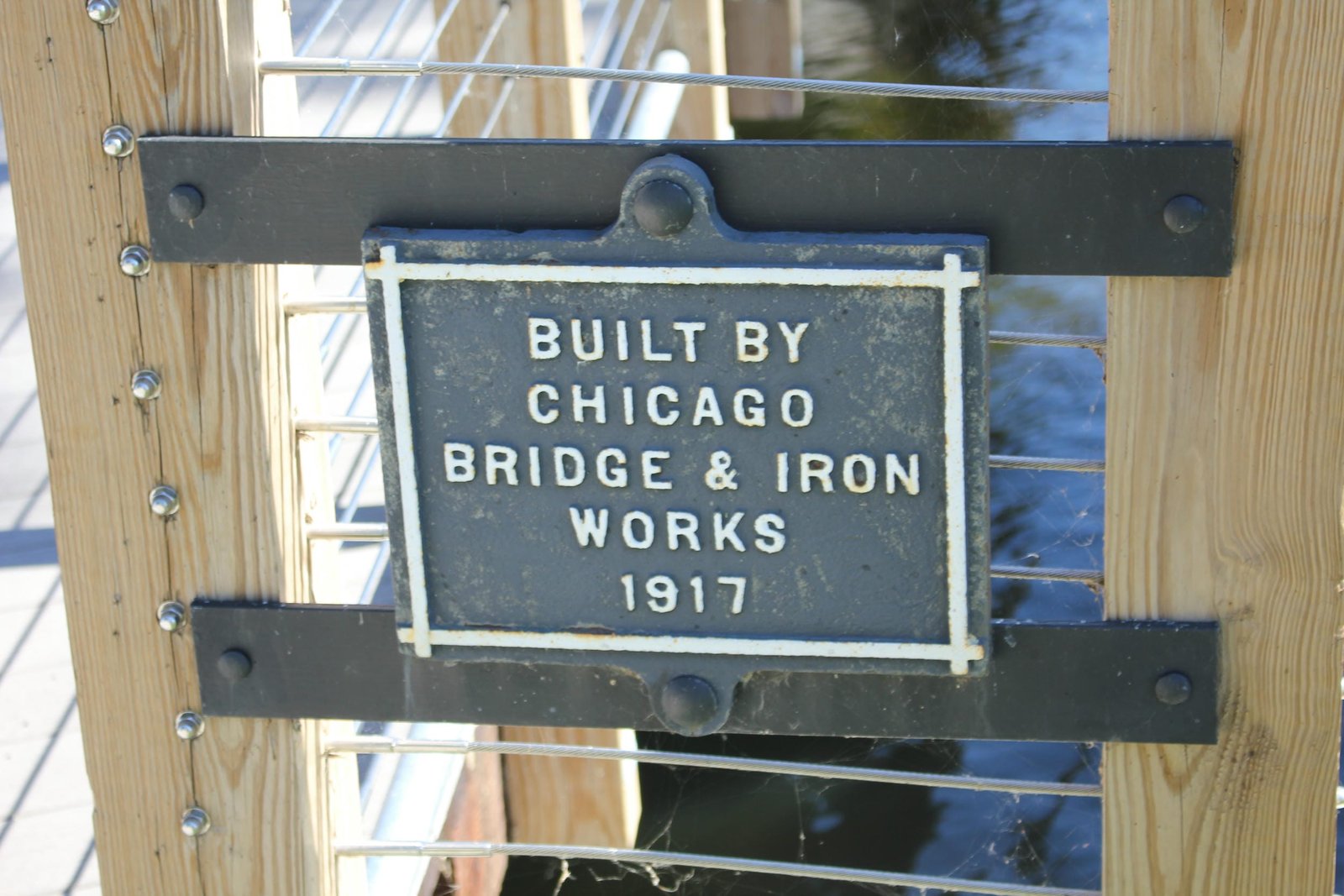 Plaque, refurbished and preserved as a monument on the west end of the bridge